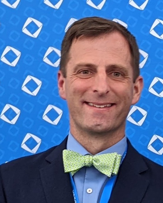 Justin Staub in a green bowtie at a DECA conference